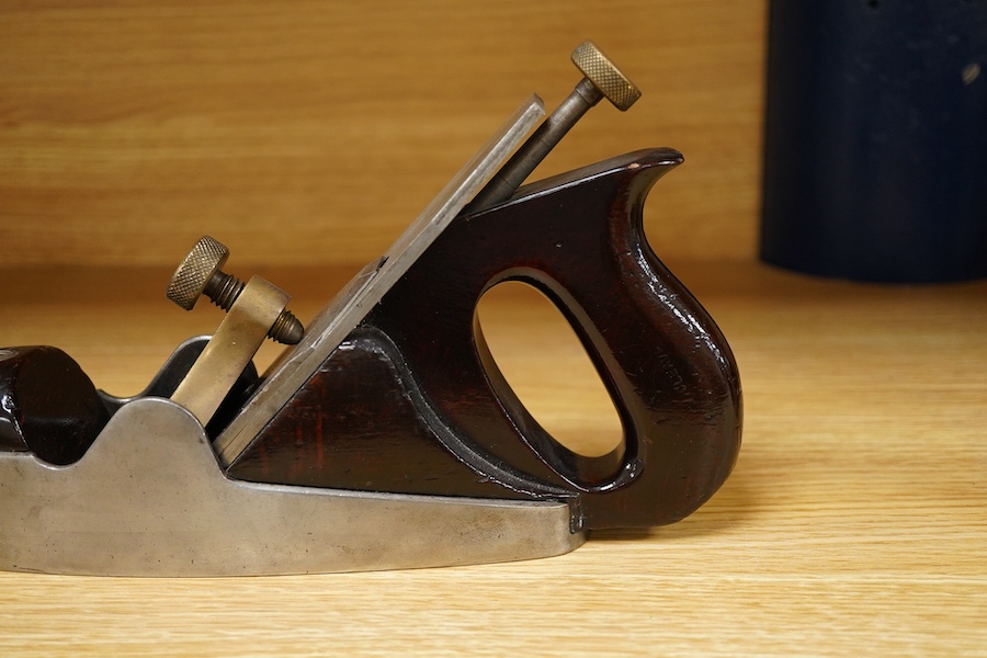 A Norris adjustable smoothing plane, stamped with Norris, London to the brass lever cap, with replacement iron, owner’s name lightly stamped to both sides of the handle, the front infill with a screw inserted down throug